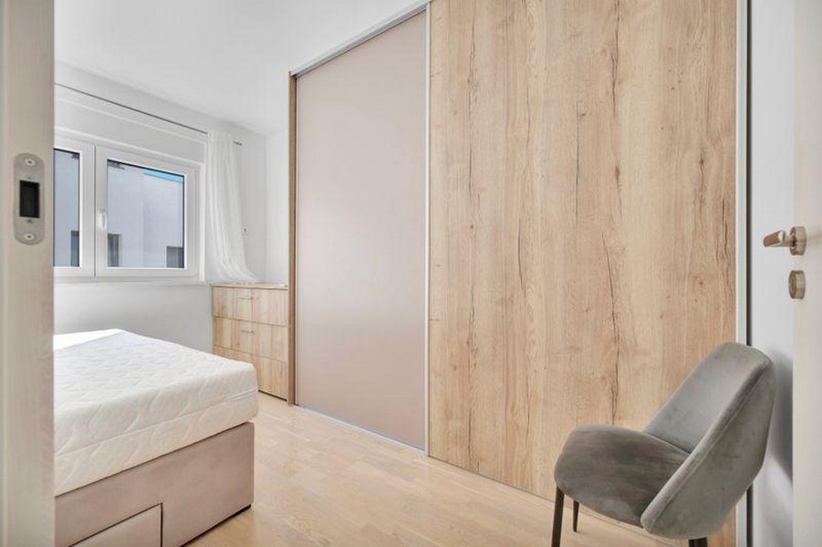 Bedroom with bed and sliding door wardrobe