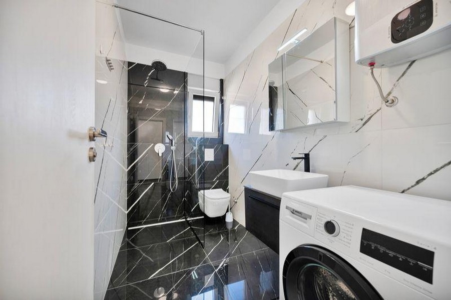 Bathroom with shower and washing machine