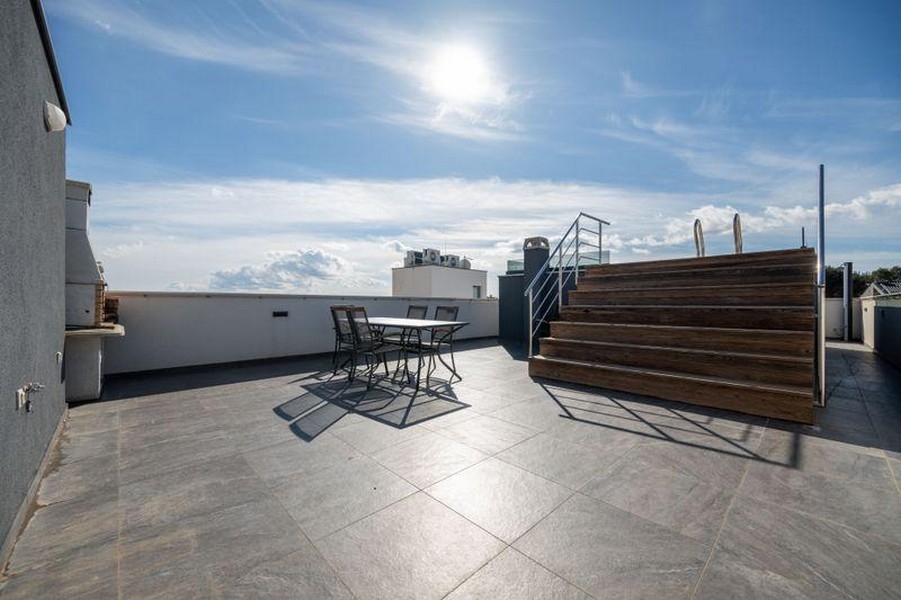 Large roof terrace with seating and wooden deck