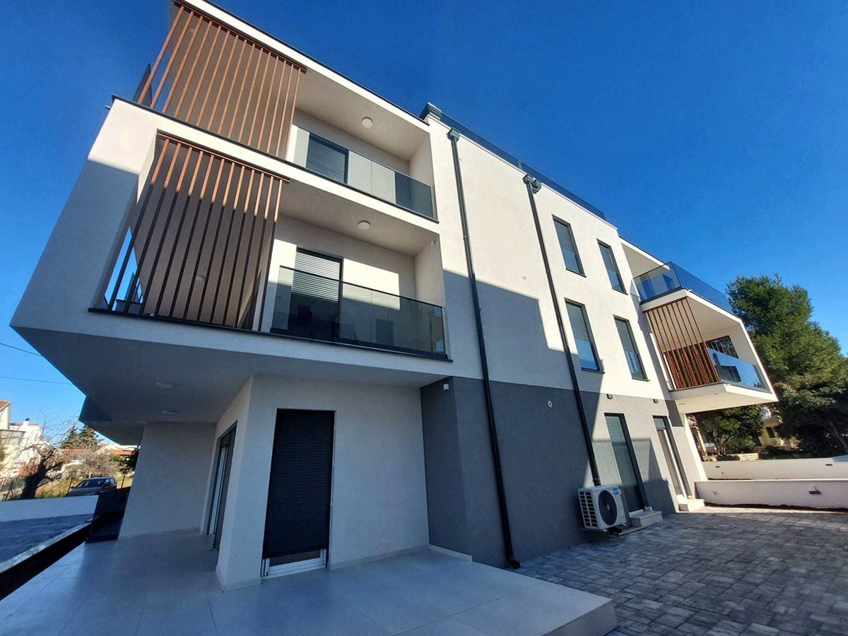 Low-angle view of the facade with timber slats and glass balustrades