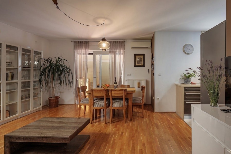 Cozy dining room with wooden furniture in an apartment for sale in Croatia.