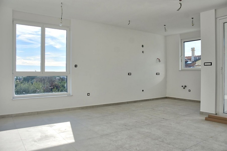 Spacious and bright living room of a luxury apartment in Istria with a large window and a view of the countryside