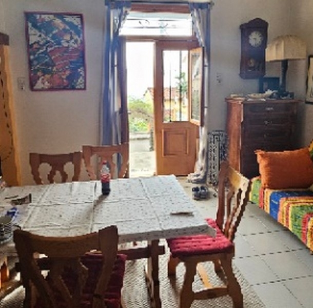 Dining room with large window opening onto an outdoor area and traditional furniture