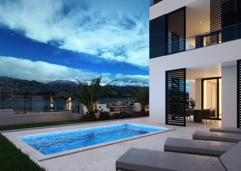 Evening view of an apartment with illuminated pool in Vinjerac, Zadar, Croatia, for sale