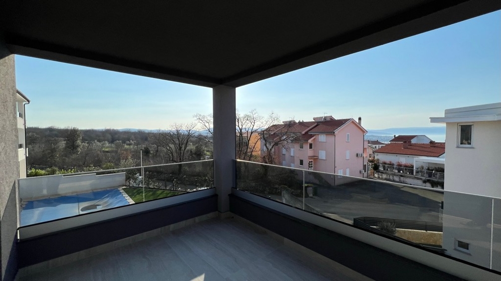 Loggia with glass balustrade and view over the neighbouring houses