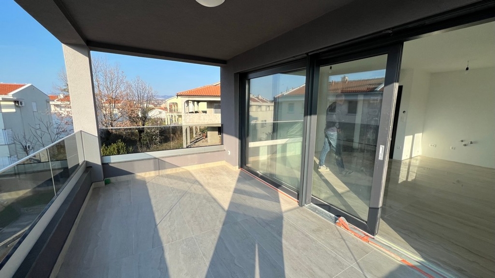 Spacious terrace with large glass windows, a highlight of the modern property on Krk Island.