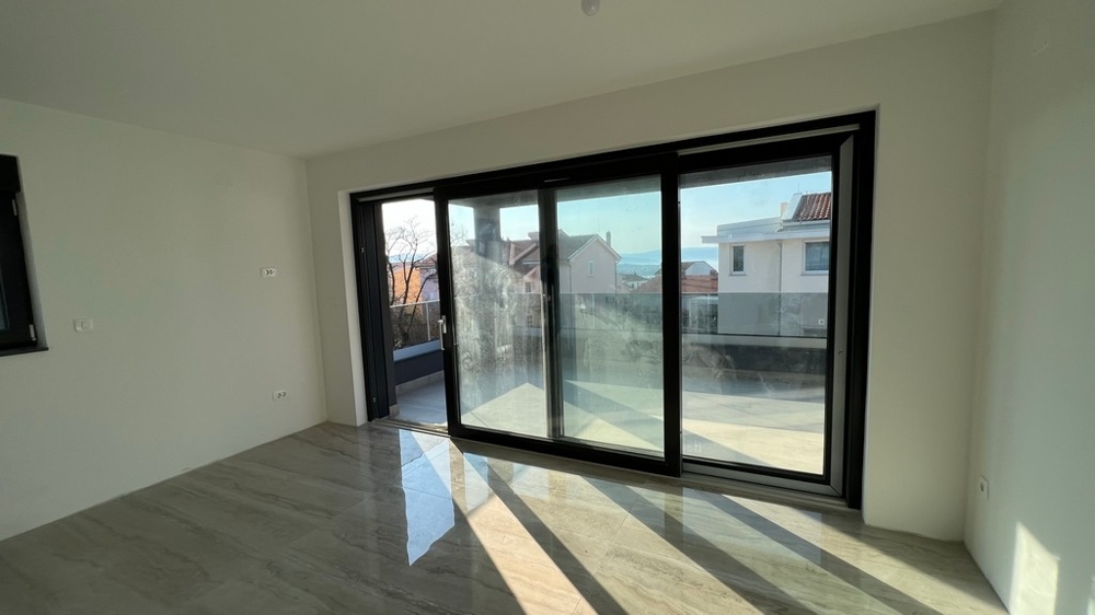 Bright living area with floor-to-ceiling windows, fitting in with the modern concept of the property on Krk Island.