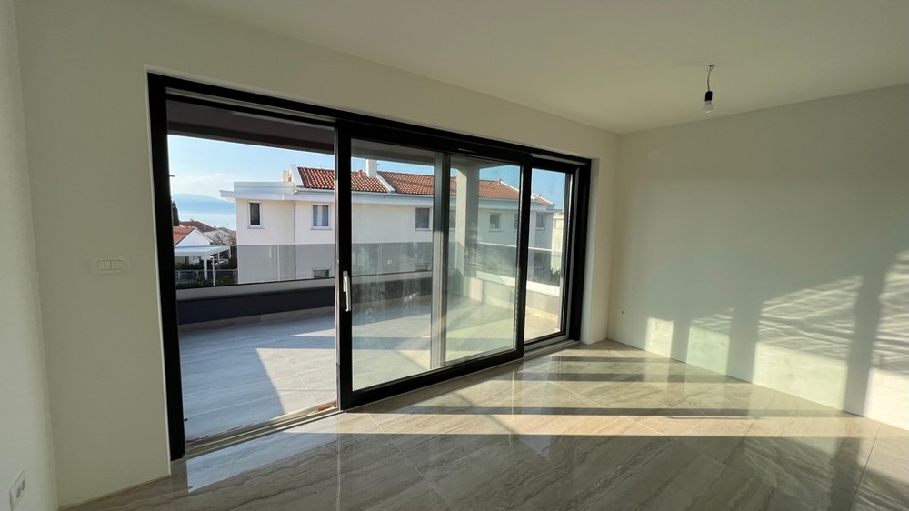 Living room with direct access to the terrace, emphasising the open sense of space of the property on Krk Island.
