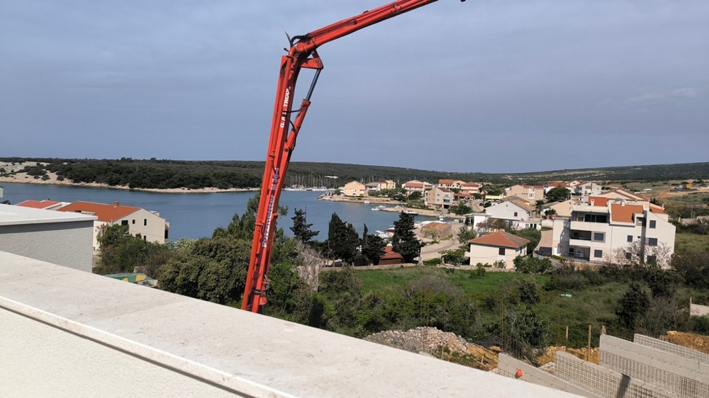 View from a new build penthouse on Simuni, Croatia property with sea views and a crane in the foreground.