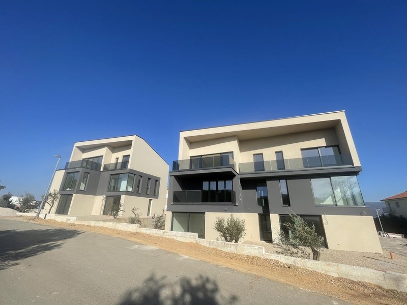 The two new residential buildings along the road