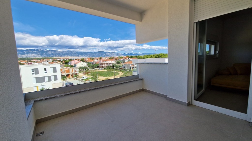 Balcony view of an apartment in Novalja, Pag island, with sea view and urban surroundings, Croatia real estate