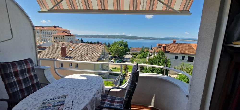 Apartments with sea view in Croatia - balcony with table and chairs, view of the sea