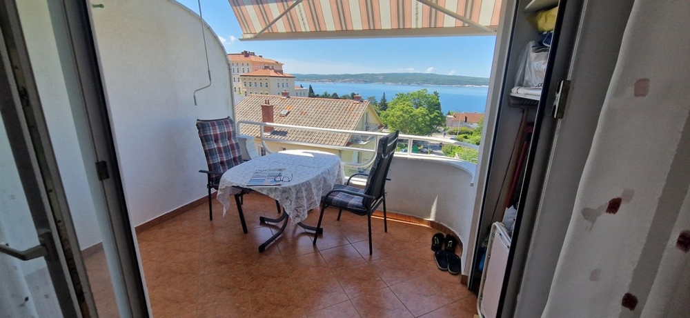 Apartments with sea view in Croatia - balcony with table and chairs, view of the sea