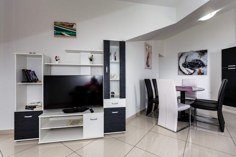 Living room with dining table and TV bench.