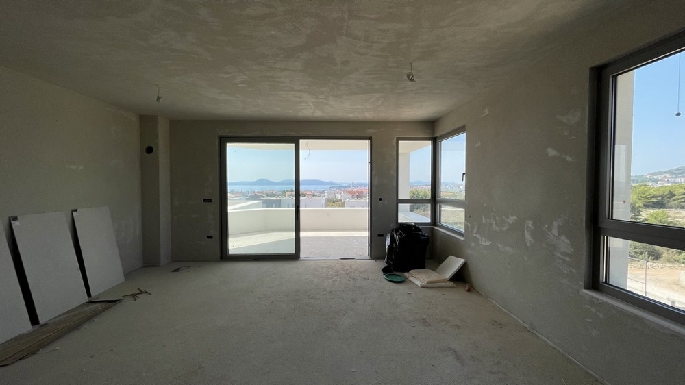 Open living and dining area with window front and sea views, penthouse A3577 under construction.