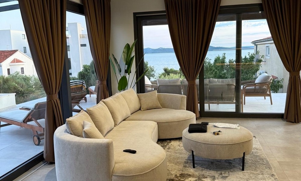 Living area with large window front and sea view