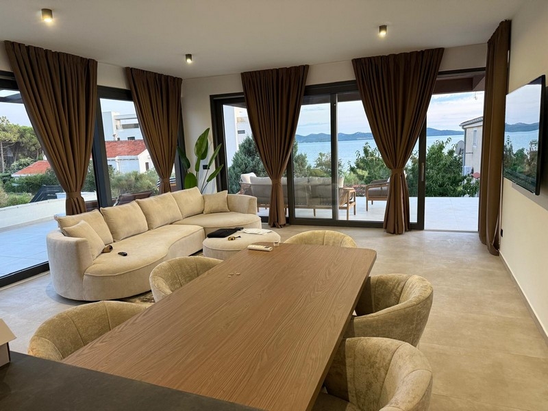 Open living and dining area with terrace and sea views