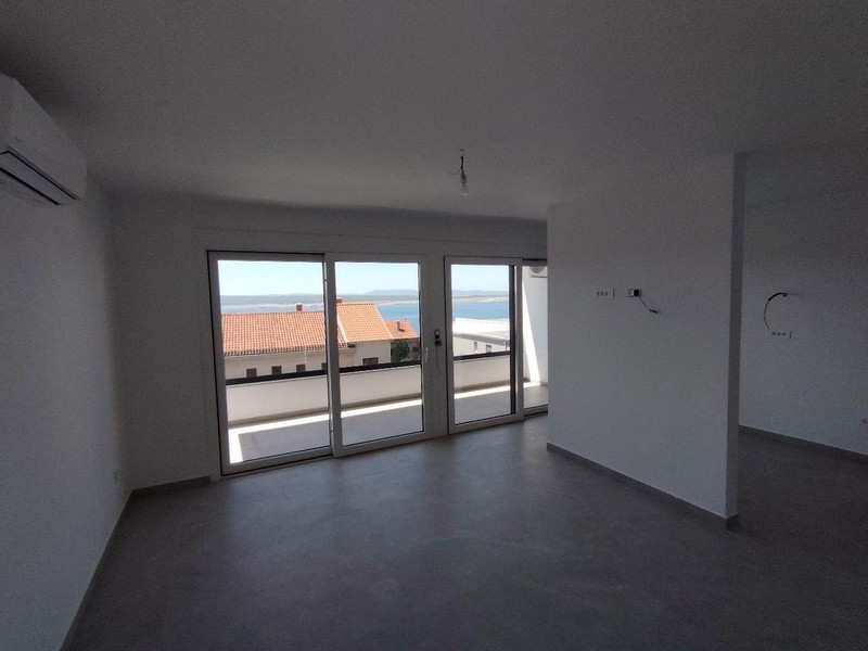 Bright living room with large window fronts and sea views