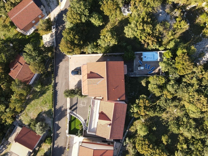Aerial view of residential house with pool in green surroundings in Crikvenica