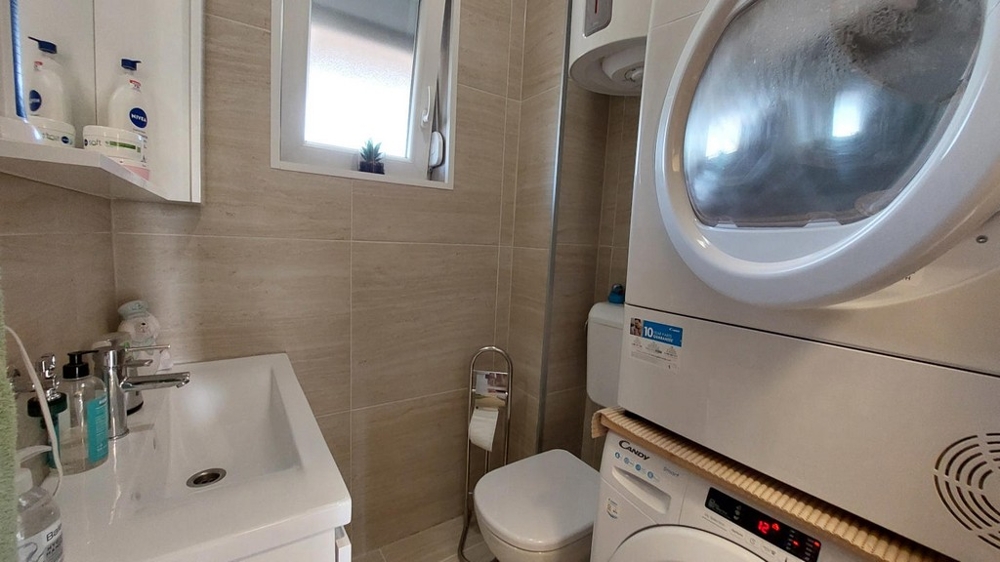 Bathroom with washing machine and dryer