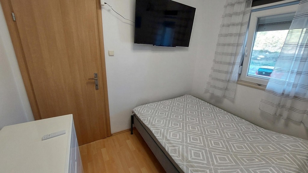 Second bedroom with single bed and TV