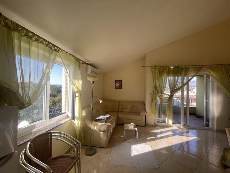 Living area with sofa and access to the balcony with sea views