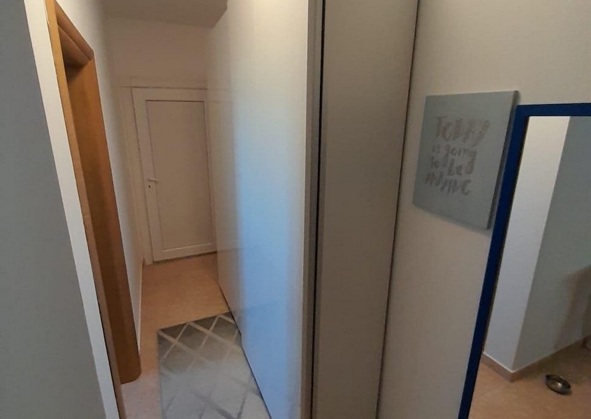 Hallway with built-in wardrobe and wall mirror