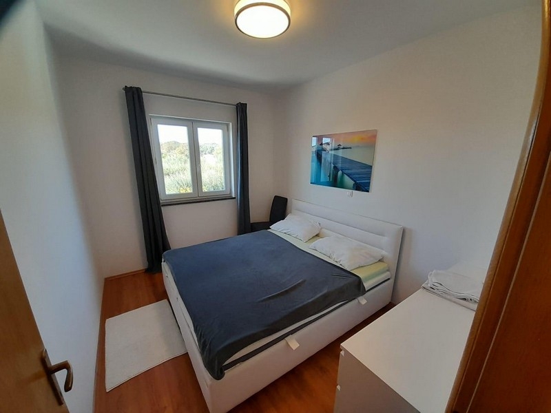 Bedroom with double bed, window and mural