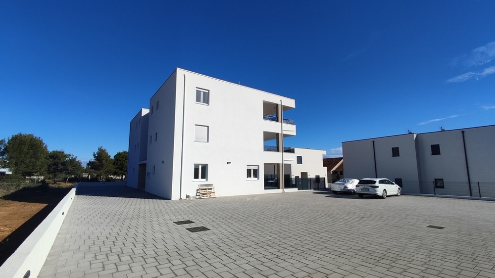 Exterior view of modern residential building with parking spaces