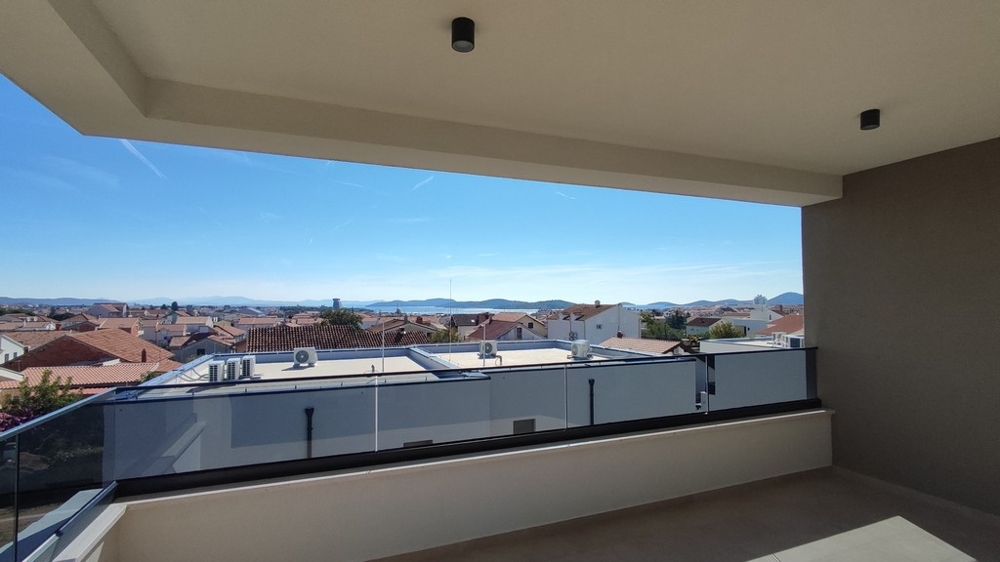 Wide view of roofs and sea from the terrace