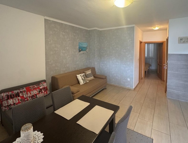 Living room with sofa and view of the hallway