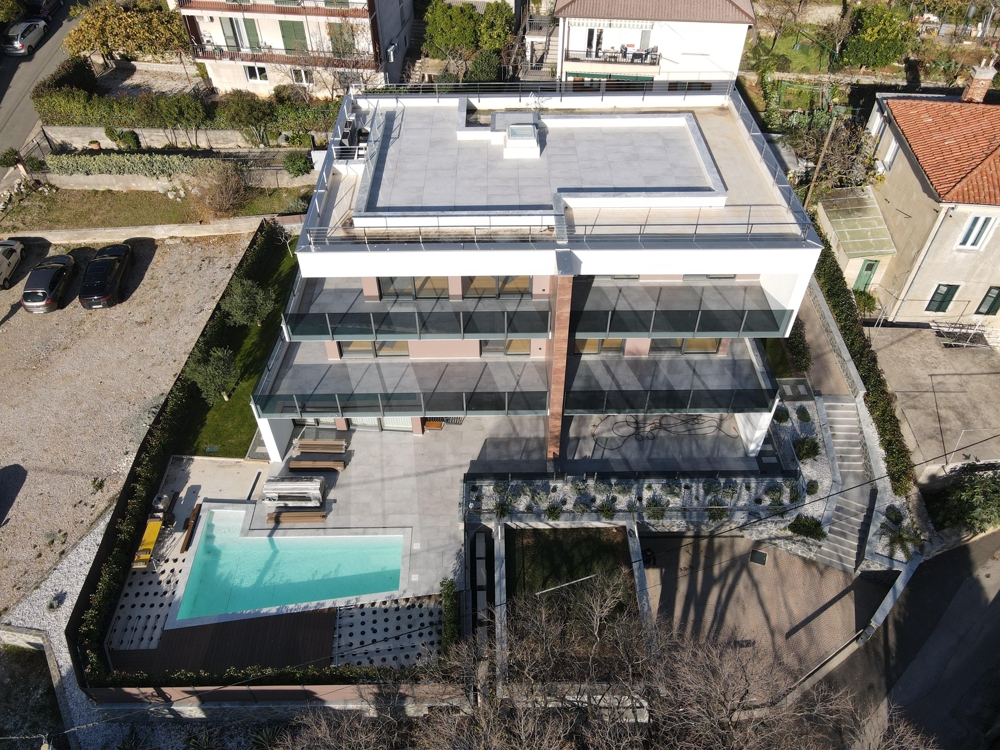 Aerial view of modern residential building with pool