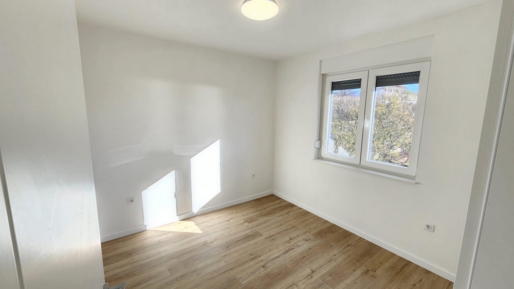 Another bedroom with wooden floors