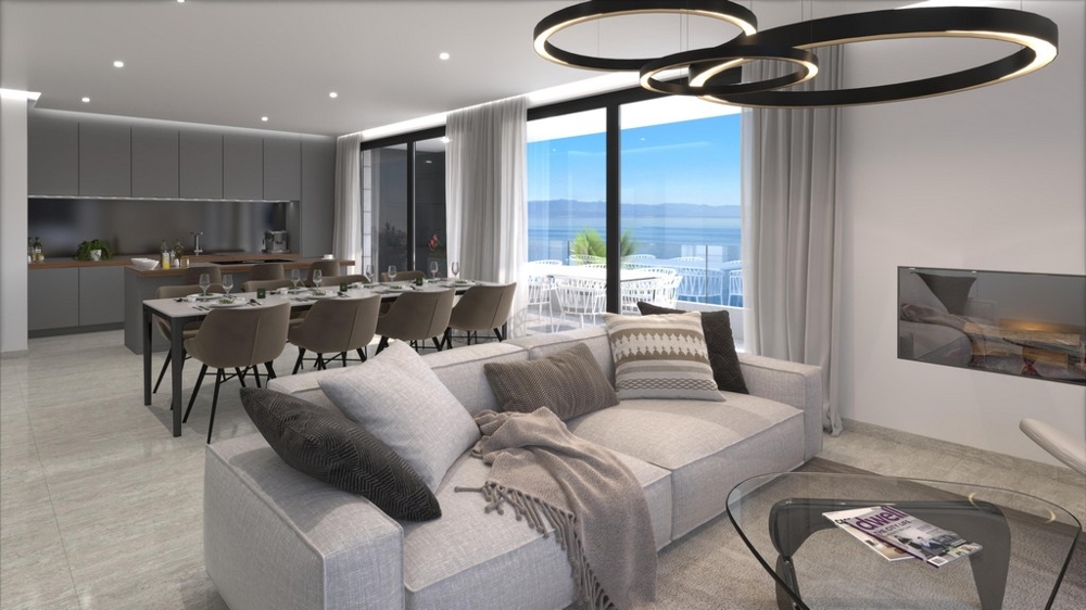 Open plan living and dining area with kitchen and sea views