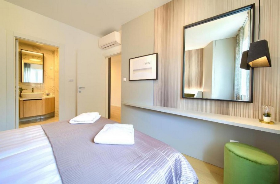 Bedroom with bathroom access and mirror