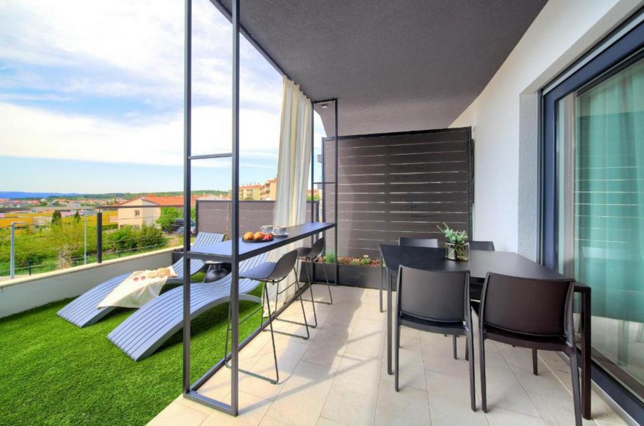 Terrace with dining area and view of the greenery