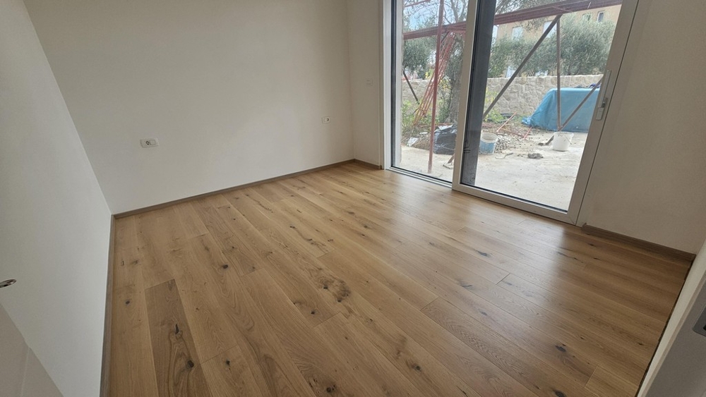 Bedroom with parquet floors and garden access