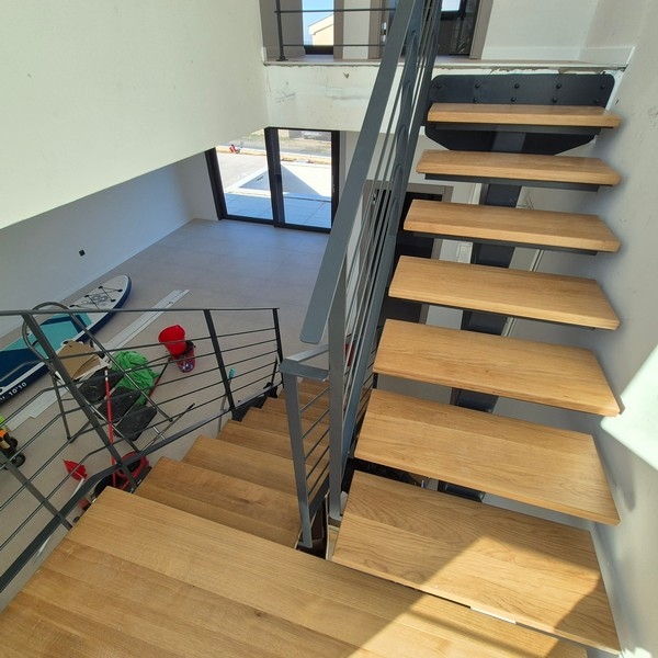 Wooden staircase with metal railing indoors