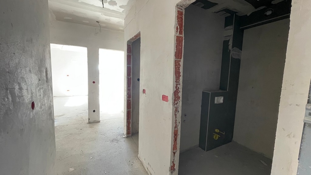 Hallway with access to bathroom and living area