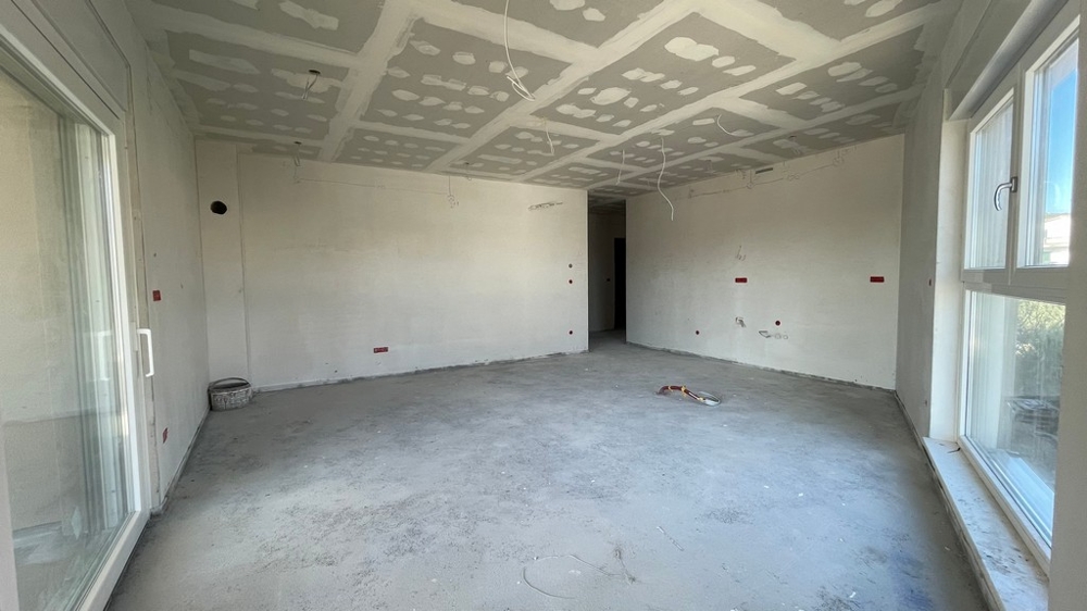 Open living room with kitchen in the shell