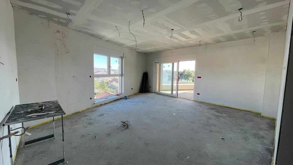 Living area with window and patio door