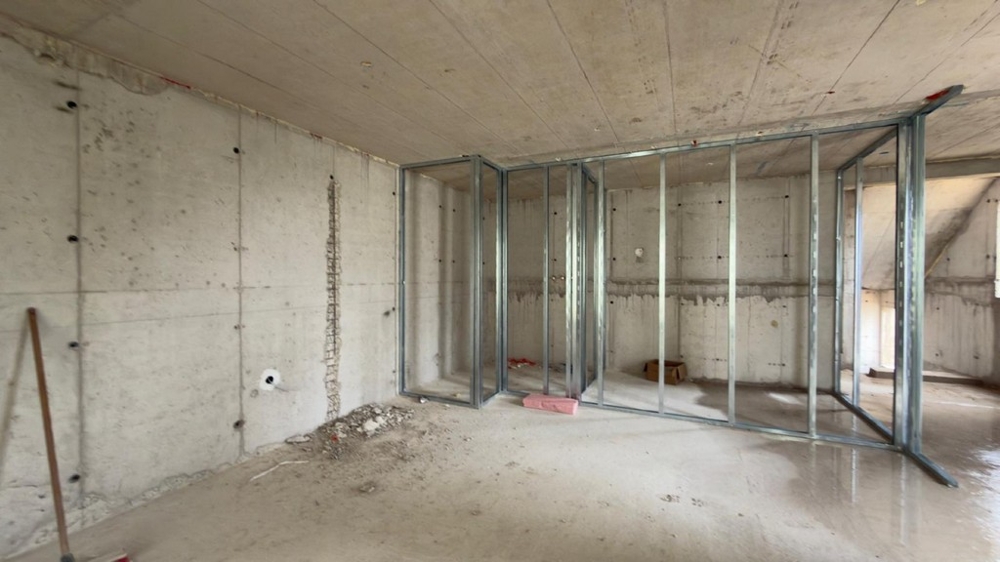 Unfinished bedroom with drywall walls
