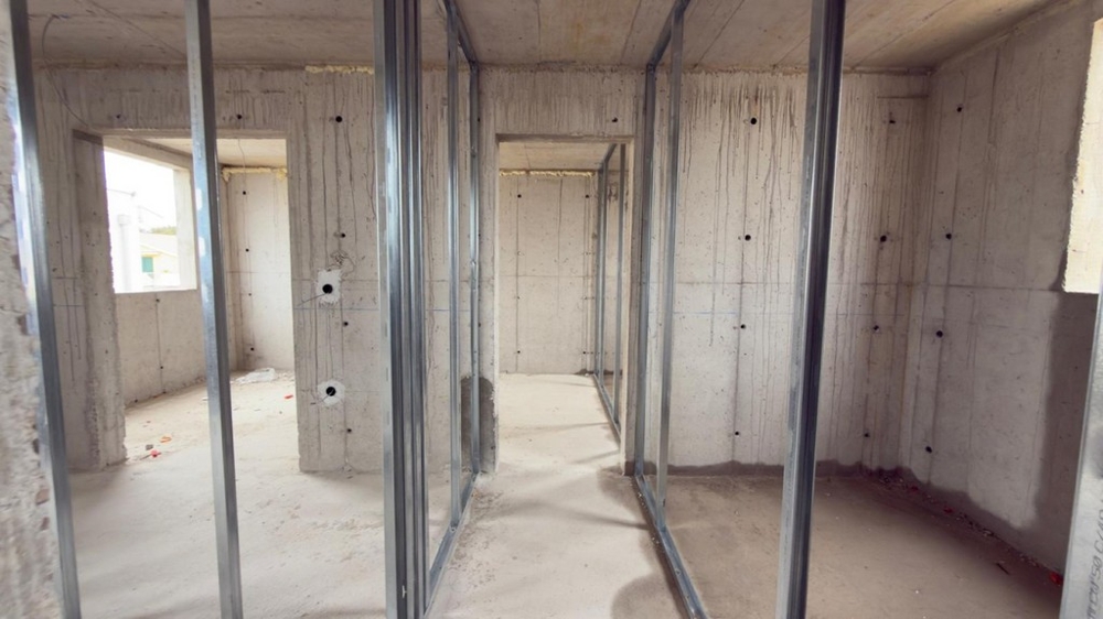 Hallway in shell construction with prepared drywall walls