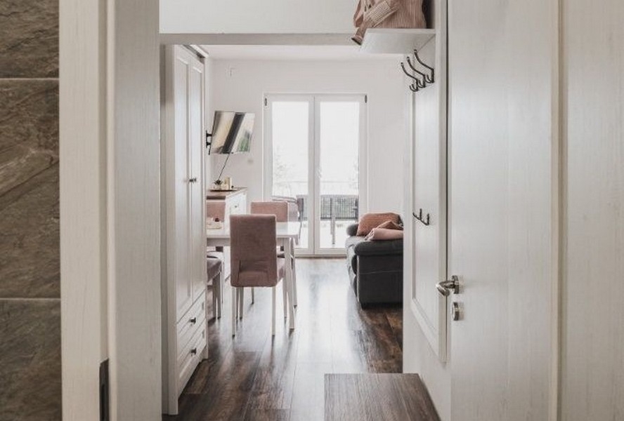Hallway with a view of the living area and balcony
