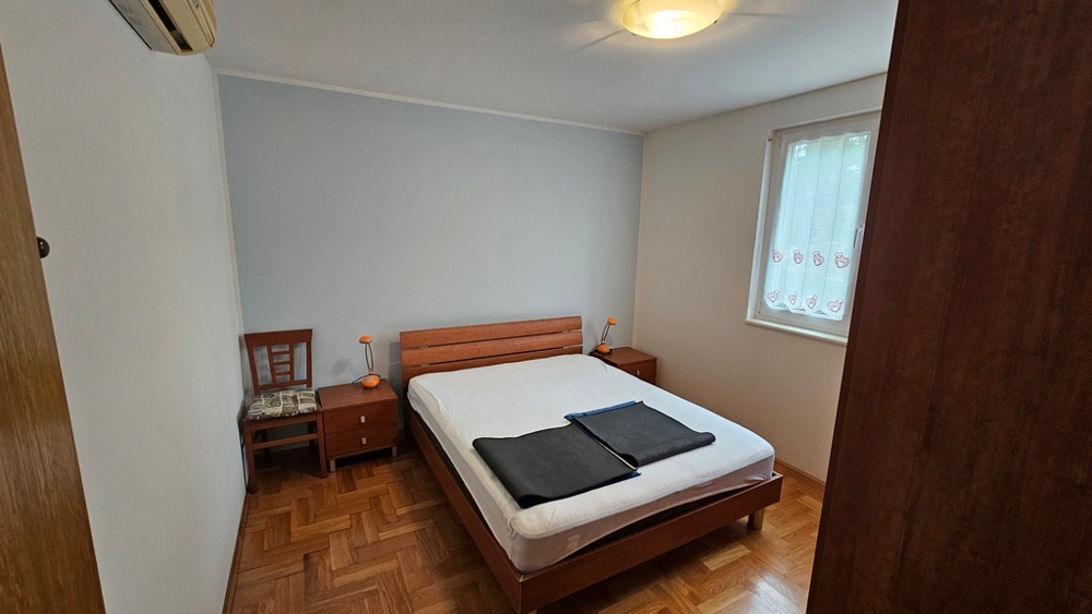 Bedroom with double bed and parquet floor