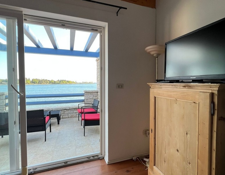 Living area with terrace access and direct sea views
