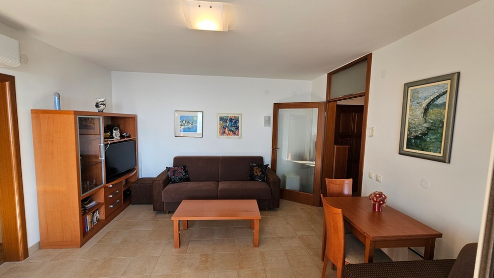 Living room with sofa, TV furniture and dining area