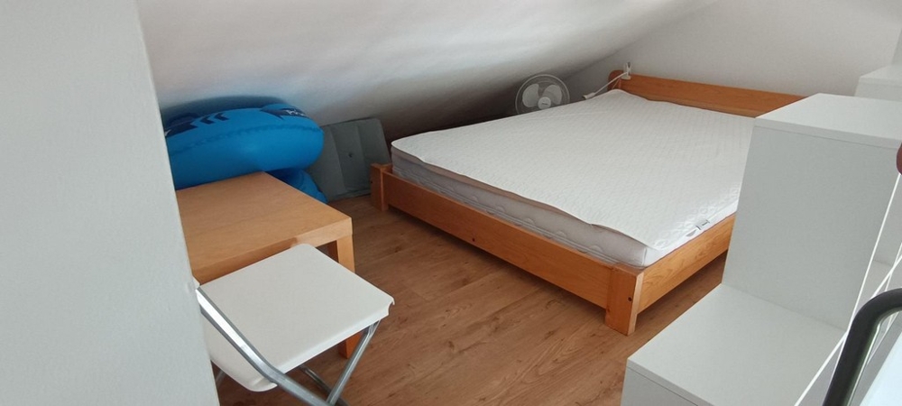 Sleeping area on the gallery with a sloping ceiling