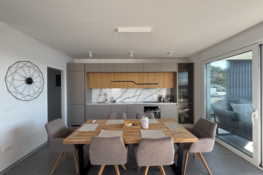 Modern fitted kitchen with dining area and large window front