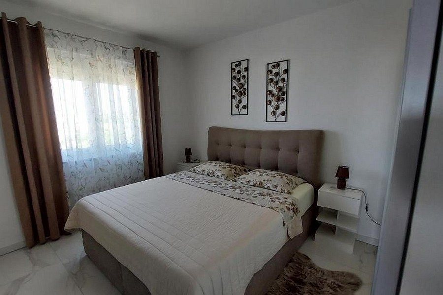 Bedroom with upholstered bed and window